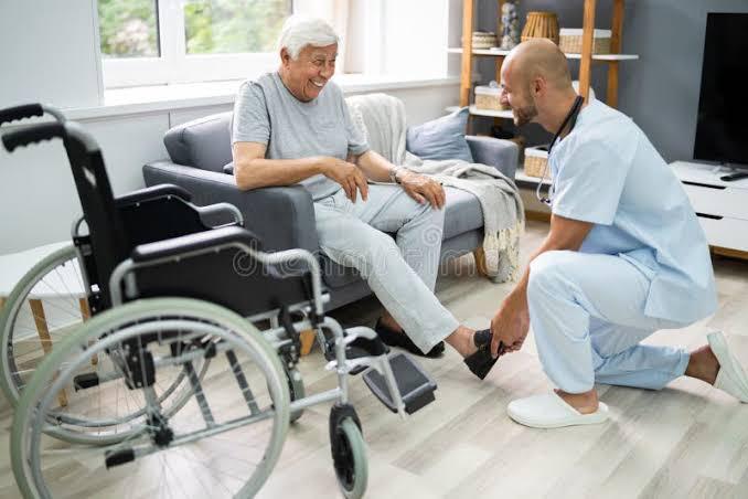 Compassionate home care nurse helping patient