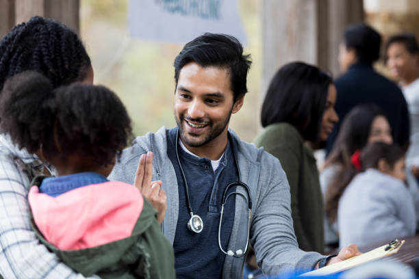 Volunteer doctor standing in clinical workspace